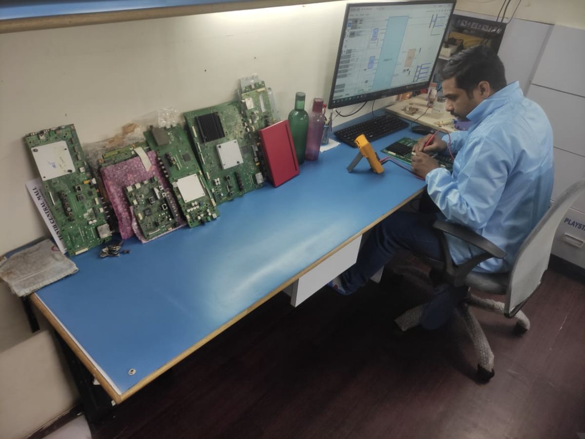 Technician testing a TV main board