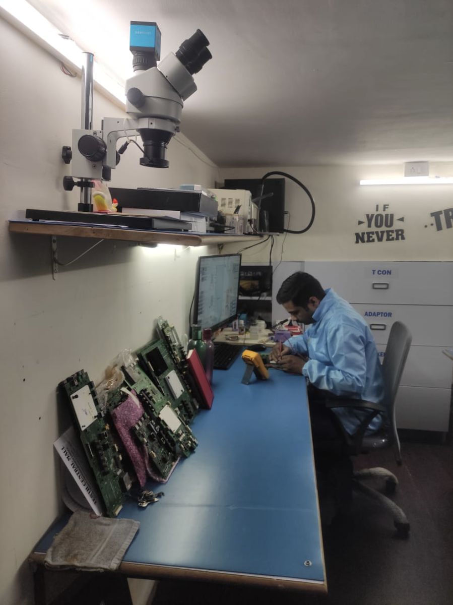 Braviaa Services workbench with microscope and TV main boards